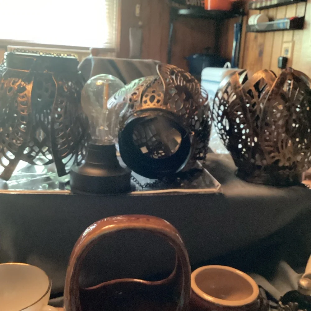 3 ornate tree lanterns outside